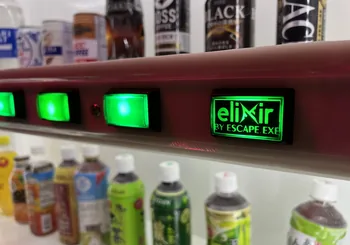 Lit push buttons on a vending machine inside one of the rooms